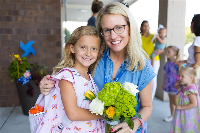 Two people smile at Scales Elementary